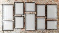 Collection of ten white empty frames hanging on brick wall mockup for versatile design presentations Royalty Free Stock Photo