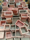 Collection of terracotta planters arranged in organized rows on a workshop floor Royalty Free Stock Photo