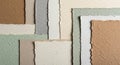 A collection of textured paper sheets of varying sizes and colors is arranged Royalty Free Stock Photo