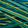 A collection of thin, flat sticks in various shades of green and blue, arranged Royalty Free Stock Photo