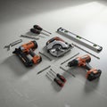 A collection of tools arranged on a smooth gray surface includes an orange and black Royalty Free Stock Photo