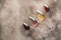 Collection of varied wines in glass flat lay on rustic background. Top view