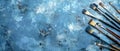 A collection of various art brushes arranged on a textured blue surface, capturing the tools of creativity and artistic expression Royalty Free Stock Photo