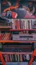 Collection of Various Books on Shelves in Library and vintage Grundig and Philips stereo radio, amplifier, a fedora hat