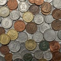 A collection of various coins scattered randomly. They exhibit different designs, sizes Royalty Free Stock Photo