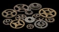 Assortment of Metal Gears and Cogs on a Black Background mechanical machinery Royalty Free Stock Photo