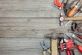 collection of various old hand tools including hammer pliers wrenches and nipper on wooden background Royalty Free Stock Photo