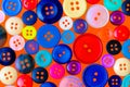 Collection of various sewing buttons on a red background