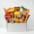 A collection of various snacks arranged in a white box. Visible items include potato Royalty Free Stock Photo