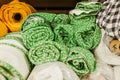 Collection of vibrant green knitted fabric rolls arranged in a neat pile Royalty Free Stock Photo