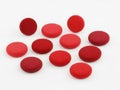 Collection of vibrant red circular objects arranged on a plain surface Royalty Free Stock Photo