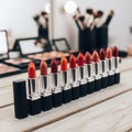 A collection of vibrant red lipsticks arranged on a wooden surface Royalty Free Stock Photo