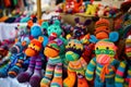 a collection of vibrant sock puppets for sale at a craft market