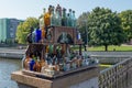 Collection of vintage clear vessels in shades of blue, green and brown on a vintage wooden street vendor`s rack