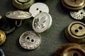 Collection of vintage clothing buttons. Dark stone background, grunge photo.