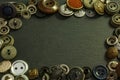 Collection of vintage clothing buttons. Dark stone background, grunge photo. Royalty Free Stock Photo