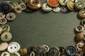 Collection of vintage clothing buttons. Dark stone background, grunge photo. Royalty Free Stock Photo