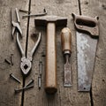 A collection of vintage hand tools is arranged on a rustic wooden surface Royalty Free Stock Photo