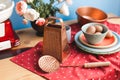 Collection of vintage kitchenware with red tablecloth, blue background