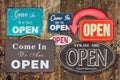 Vintage open signs hanging on an antique weathered wooden wall