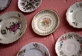 A Collection Of Vintage Plates On A Pink Cinderblock Wall