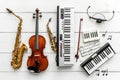 A collection of violins, pianos, and other instruments arranged on a table Royalty Free Stock Photo