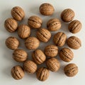 A collection of walnuts (Juglans regia) arranged on a light surface. The walnuts Royalty Free Stock Photo