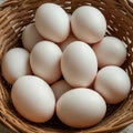 A collection of white eggs is placed in a woven wicker basket. The eggs are smooth an Royalty Free Stock Photo