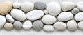 A collection of white, gray, and beige stones arranged in a row. Royalty Free Stock Photo