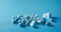 A collection of white pills on a blue background Royalty Free Stock Photo