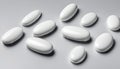 A collection of white pills on a white background