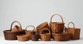 A collection of wicker baskets is arranged on a neutral background. The baskets vary Royalty Free Stock Photo