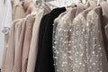 collection of women\'s festive elegant clothes with sequins and rhinestones on hangers in the store. the concept of conscious