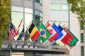 Collection of world flags hanging on flag poles on building Royalty Free Stock Photo