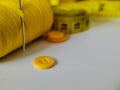 A collection of yellow sewing accessories on a white background Royalty Free Stock Photo