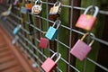 Collections of Colorful Metal Padlocks Hanging on a Fence Panel of a Bridge Royalty Free Stock Photo