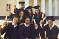 Collective photo of smiling boys and girls students university graduates celebrating getting diplomas Royalty Free Stock Photo