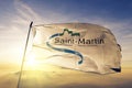 Collectivity of Saint Martin flag textile cloth fabric waving on the top sunrise mist fog