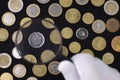 Collector or expert looking at coins in magnifying glass, top view of coin collection on black Royalty Free Stock Photo