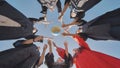 College alumni students toss a globe of the world into the sky. Royalty Free Stock Photo