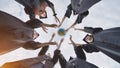 College alumni students toss a globe of the world into the sky. Royalty Free Stock Photo