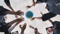 College alumni students toss a globe of the world into the sky. Royalty Free Stock Photo
