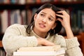 College, anxiety and girl with books at campus library overwhelmed by deadline, mistake and burnout. University, stress Royalty Free Stock Photo