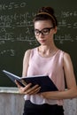 college female student writing on blackboard completing mathematical equations Royalty Free Stock Photo