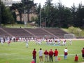 College Football Player in action as coaches watch