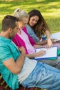 College friends sitting on campus bench Royalty Free Stock Photo
