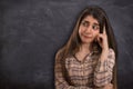 College girl thinking with blank blackboard Royalty Free Stock Photo