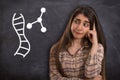 College girl thinking with DNA molecule Royalty Free Stock Photo