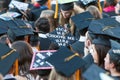 College Graduate Wears Mortarboard With Message To Potential Employers