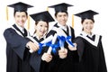 College graduates in graduation gowns standing and smiling